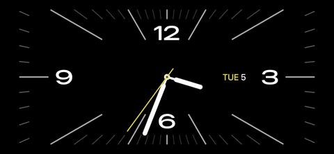 من iPhoneIslam.com، ساعة تعرض الوقت على شاشة سوداء بنظام iOS 17.